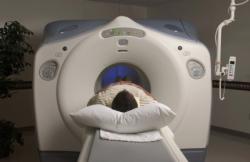 A person in hospital lying on an MRI table  A person in hospital lying on an MRI table
