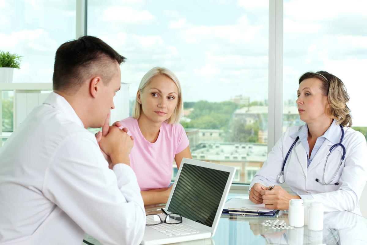 Doctors and a patient concerned-doctor-checking-patients-health